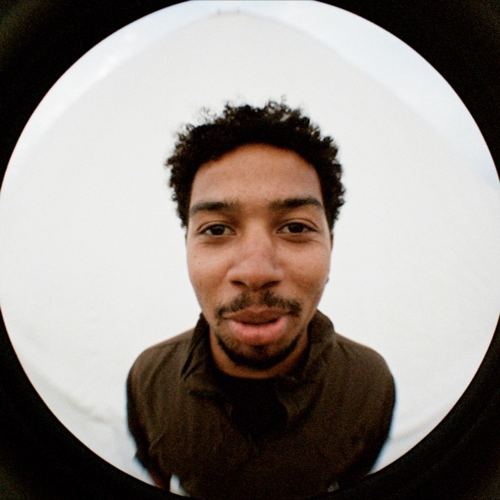 Fisheye portrait: a man in a brown jacket