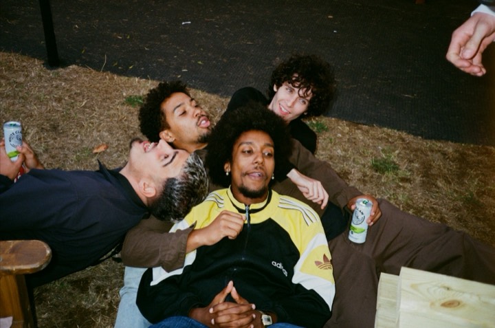 Friends lying in the straw, laughing