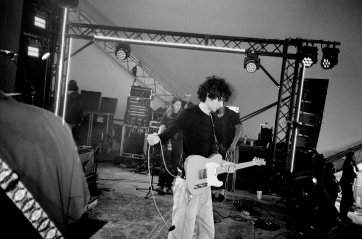 A guitarist playing on stage, in black and white