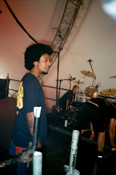 A drummer seen from the side of the stage