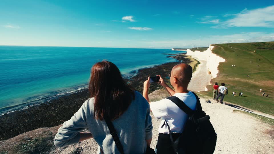 Still from Jojo in Seven Sisters: Jolie and her dad walk toward the white cliffs.